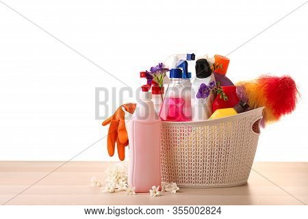 Spring Flowers And Cleaning Supplies On Wooden Table