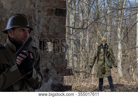 Soldier Hiding From An Enemy Behind A Wall Holding A Gun