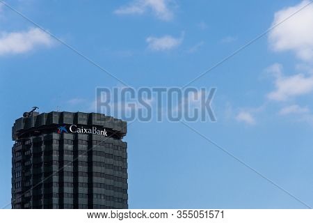 Barcelona, Spain - August 1, 2019: Building With Signs Of Caixabank Bank