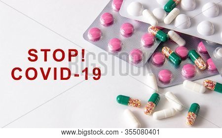 Coronavirus Phrase Text On A White Background With Medicines And Pills. The Concept Of The New 2019 