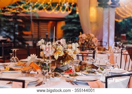 Table In Outdoor Tent Evening. Wedding Decor For A Banquet.