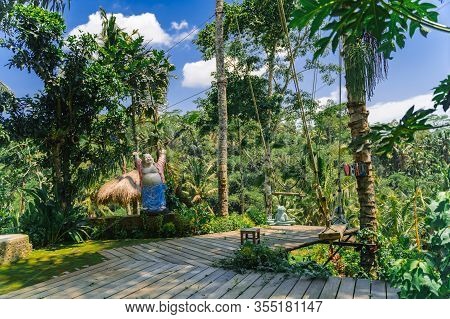 Swing In The Jungle In Bali. A Tourist Spot With Swings At The Rice Terraces Of Tegalang. Tropical T