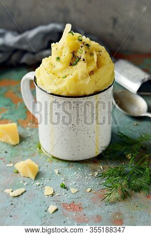 Mashed Potatoes With Butter And Olive Oil, Greens And Parmesan Slices On A Gray Background, Bowl, Cu