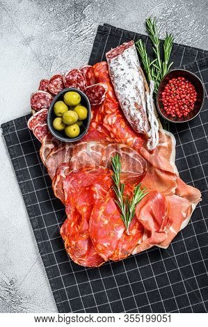 Cured Meat Platter Of Traditional Spanish Tapas. Chorizo, Jamon Serrano, Lomo And Fuet. Gray Backgro