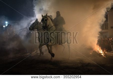 Rider Riding His Horse, Jumping Fire Fire To Purify The Animal, In A Religious Event Held In The Tow
