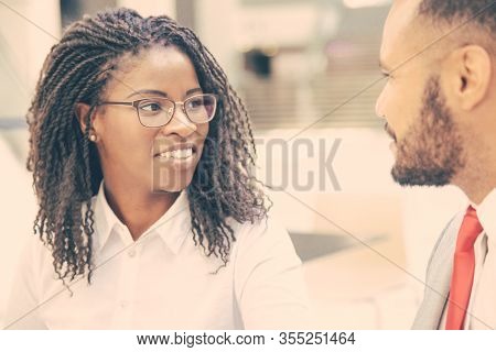 Positive Business Colleagues Enjoying Informal Talk During Work Break. Business Man And Woman Sittin