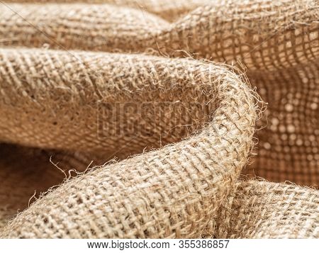 Crumpled Sackcloth, Close Up View, Abstract Background. Texture Of Brown Burlap Textile. Brown Balin