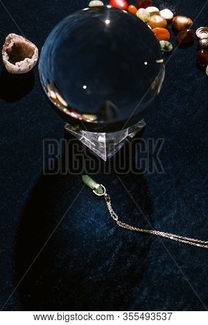 Crystal Ball And Fortune Telling Stones On Dark Blue Velour Cloth