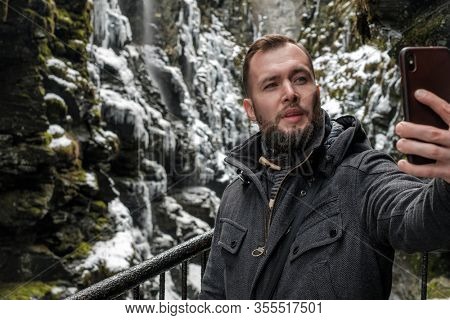 Tourist taking selfie in Bordalsgjelet gorge in Voss, Norway.