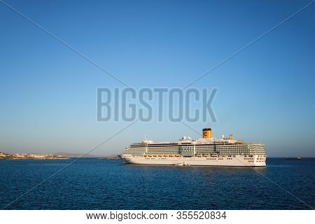 MYKONOS, GREECE - MAY 29, 2019: Cruise liner ship Costa Luminosa in Mediterranea sea near Mykonos island. Aegean sea, Greece