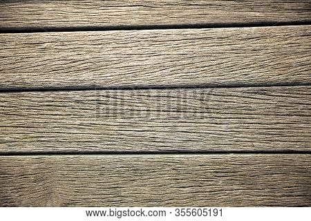 Close-up Of Brown Weathered Boardwalk Planks Background.