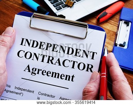 Man Is Signing Independent Contractor Agreement By Pen.