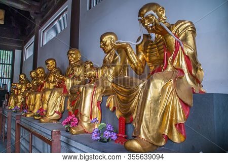 Guilin, China - May 11, 2010: Qixia Buddhist Temple In Seven Star Park. Line Of Golden Statues Of Ar