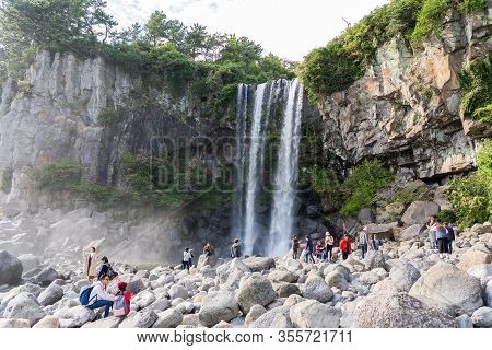 Seogwipo, Jeju Island, South Korea - November 3, 2018. Group Of People Are Taking Pictures At Waterf