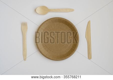 Eco- Friendly Tableware For Food And Wooden Eco-knife, Fork, Spoon On A Light Background With A Copy