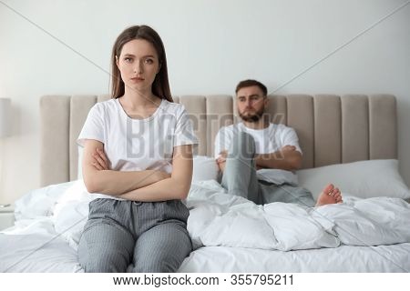 Unhappy Couple With Problems In Relationship On Bed At Home