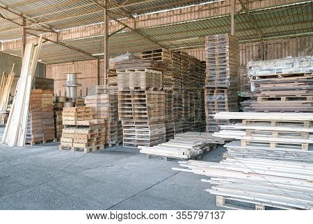 Pile Of Pine Wood In A Warehouse Or Storage Room. Wood Proceesing, Wood For Furniture