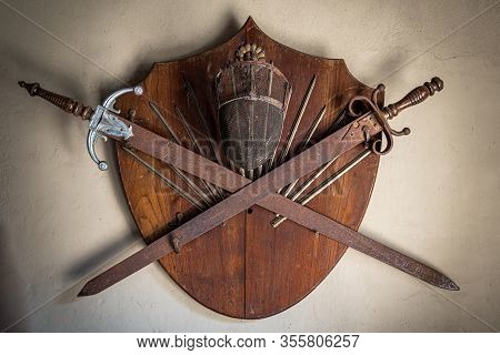 Gonzalez Catan, Argentina, September 28, 2019: Old Wooden Shield With Two Rusty Swords And A Fencing