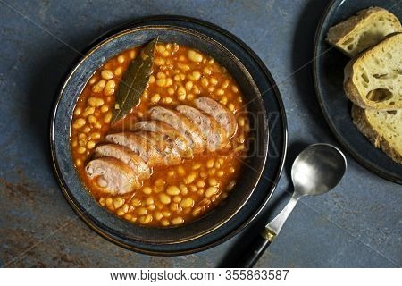 Baked Beans Stew With Tomato Sauce And Sausage With Herbs