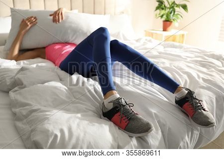 Lazy Young Woman Sleeping On Bed Instead Of Morning Training, Focus On Legs