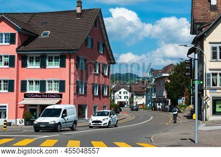 Wetzikon, Switzerland - May 14, 2022: Urban Life And Traffic On The Street Through Wetzikon At Dayti