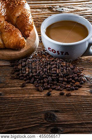 Cup Of Costa Coffee On A Wooden Table