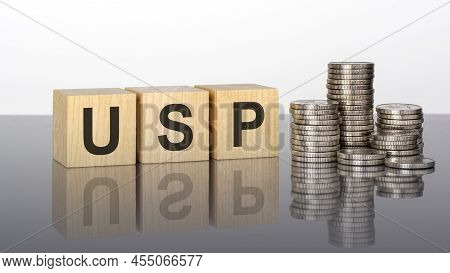 Usp - Text Is Made Up Of Letters On Wooden Cubes Lying On A Mirror Surface, Gray Background. Stacks 