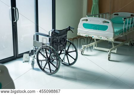 Empty Wheelchair Parked In Patient Rooms At Hospital. The Wheelchair Patient Is In The Hospital Ward