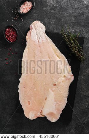 Pangasius Frozen Fillet. Raw Fillet Of White Fish Catfish. Pangasius With Spices. Black Background. 