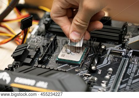 Engineer Man Applying Of Thermal Conductive Paste On Microprocessor Chip Parts. Russia, 17.08.2021
