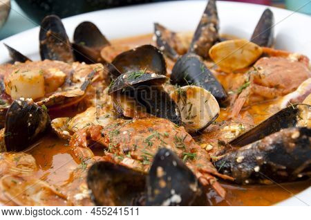 Cooked Mussels In Shells Shellfish Seafood Dish With Sauce In White Plate.