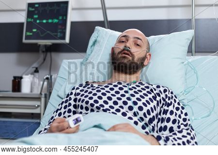 Portrait Of Patient With Breathing Problems Recieving Treatment Connected To Pulse Oximeter And Cent