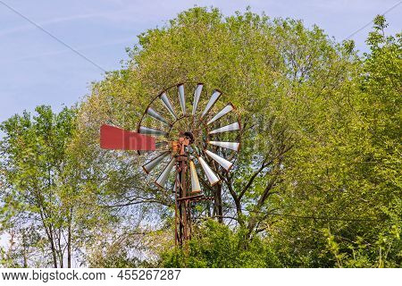 Rusty Old Style Wind Turbine Near Woods