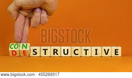 Destructive Or Constructive Symbol. Businessman Turns Cubes Changes The Concept Word Destructive To 