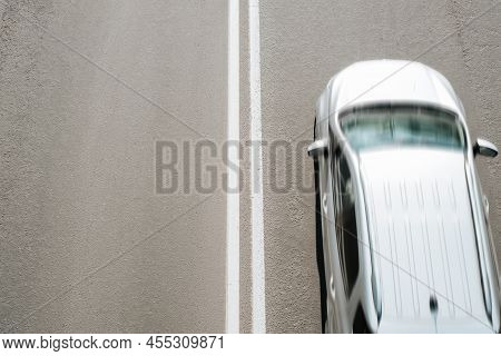 Silvery Car Driving At Fast Speed On Road, Top View. Blurred Fast Motion, Selective Focus On Dividin