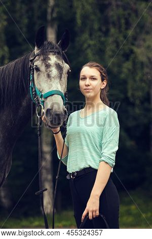 Young Girl With Grey Horse. Portrait Close Up.
