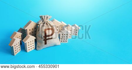 Russian Ruble Money Bag Surrounded By Houses. Real Estate Investment. Mortgage Loan. Budget And Fund