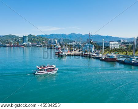 Batumi, Georgia - May 22 2022: Drone View Of A Pleasure Boat Entering The Harbor Of The City On A Su