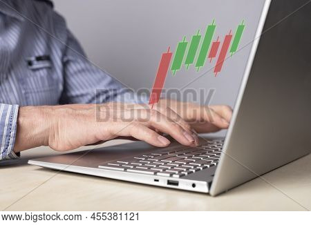 Man Using Candlestick Graph For Tracking Price Movement. Trader Hands At Laptop Keyboard. Stock Mark