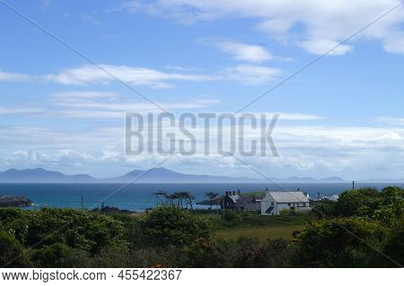 Welsh Seaside Landscape At Beautiful Anglesey Island.  View Over The Sea To The Snowdonia Mountains.