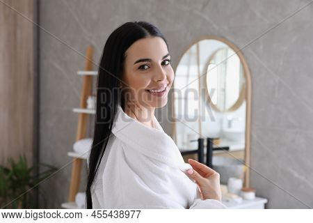 Beautiful Young Woman Wearing Soft White Robe In Bathroom