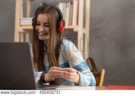 Girl Speaking In Headphones Thinking Idea Solitions. Student Woman Online Larning
