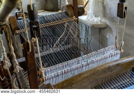 Old Instrument For Looming A Cloth And Textile In Village Style. Loom Equipment In Old House