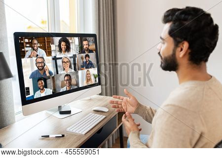 Serious Concentrated Pakistani Male Student Involved Virtual Meeting, Webinar. Man Making Video Call
