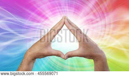Working With Rainbow Vortex Healing Energy - Male Hands Making A Triangle Shape On A Rotating Multic