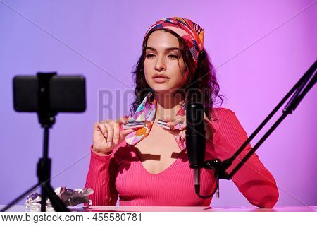Stylish Young Woman Sitting In Front Of Smartphone Camera Creating Content For Asmr Blog Recording S