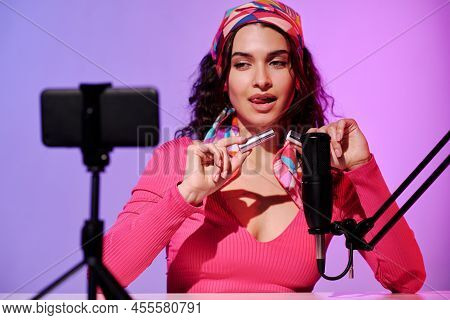 Self-confident Attractive Young Woman Sitting In Front Of Smartphone Camera Creating Content For Asm
