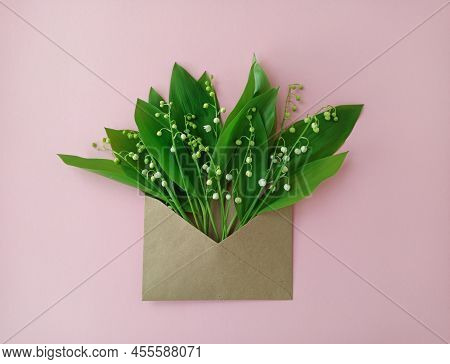 A Bouquet Of Forest Lilies Of The Valley In A Brown, Corrugated Envelope. The Arrival Of Spring. Per