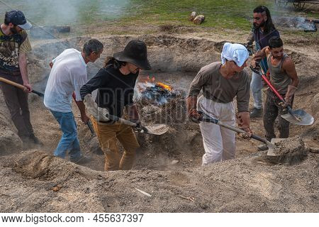 Amarante, Portugal - Circa April 2022: Stage Of Covering With Soil Of The Bonfire With The Pieces Of