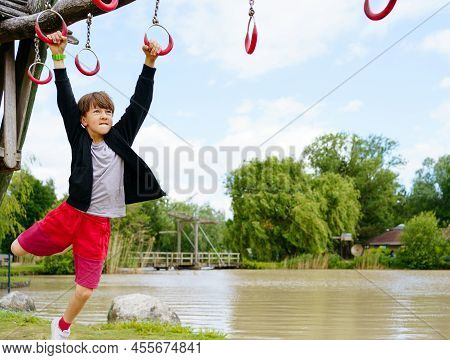 Climbing Boy On The Playground Outside In Center Parc In Niederlande